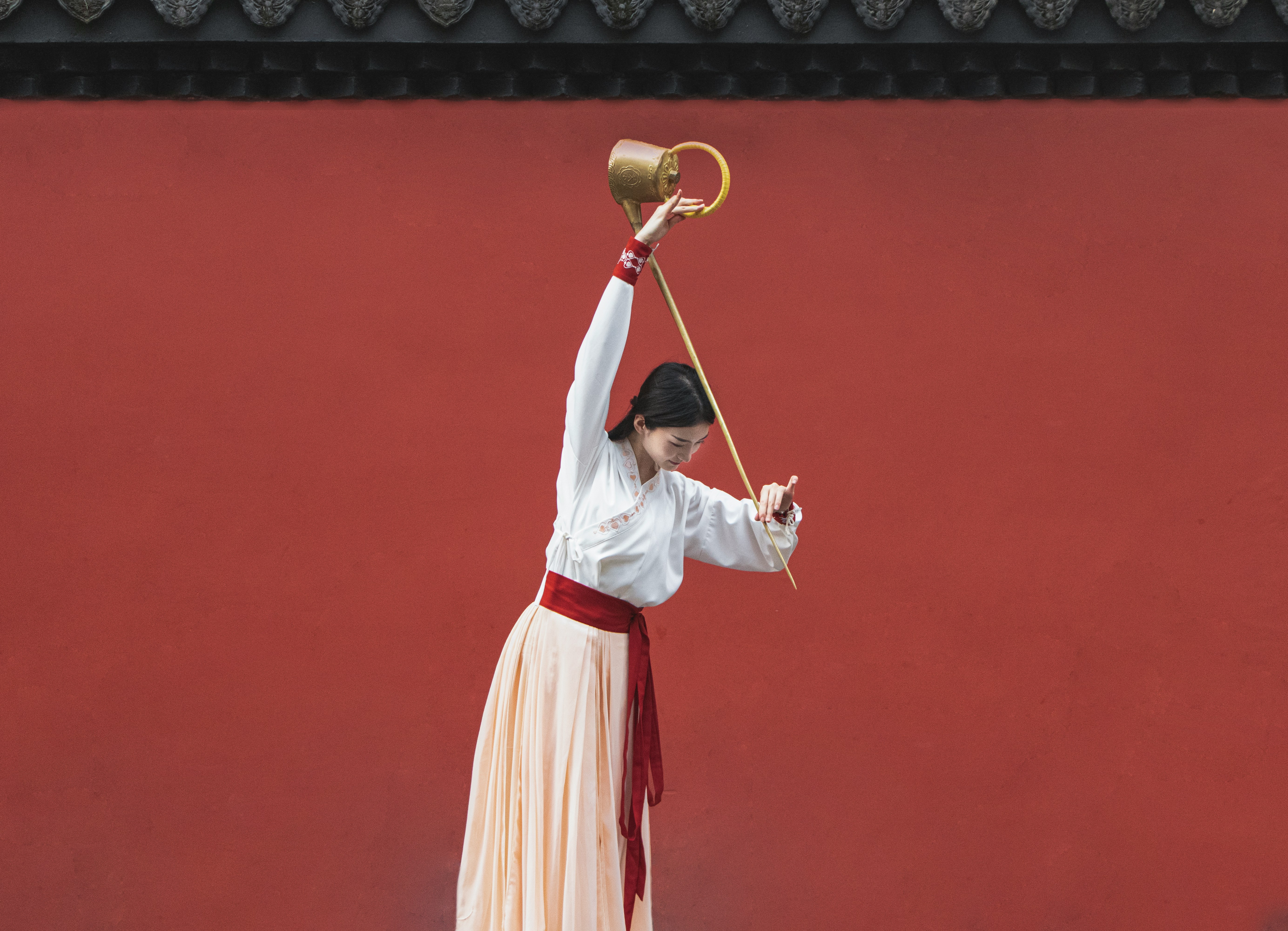 A person practicing tai chi outdoors in a serene spring park, the season linked to the Liver in Chinese medicine