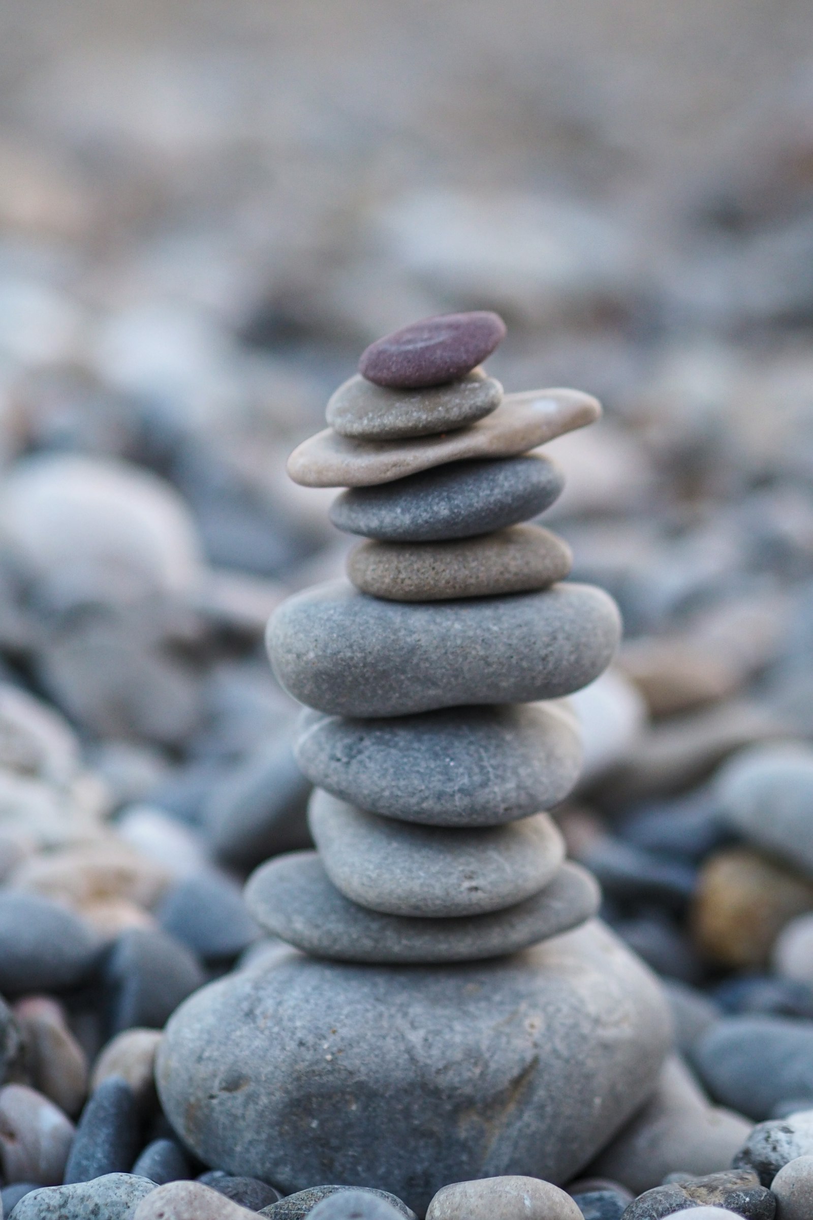 Balanced zen stones, symbolizing the calm and stability that acupressure points like Neiguan bring to the nervous system